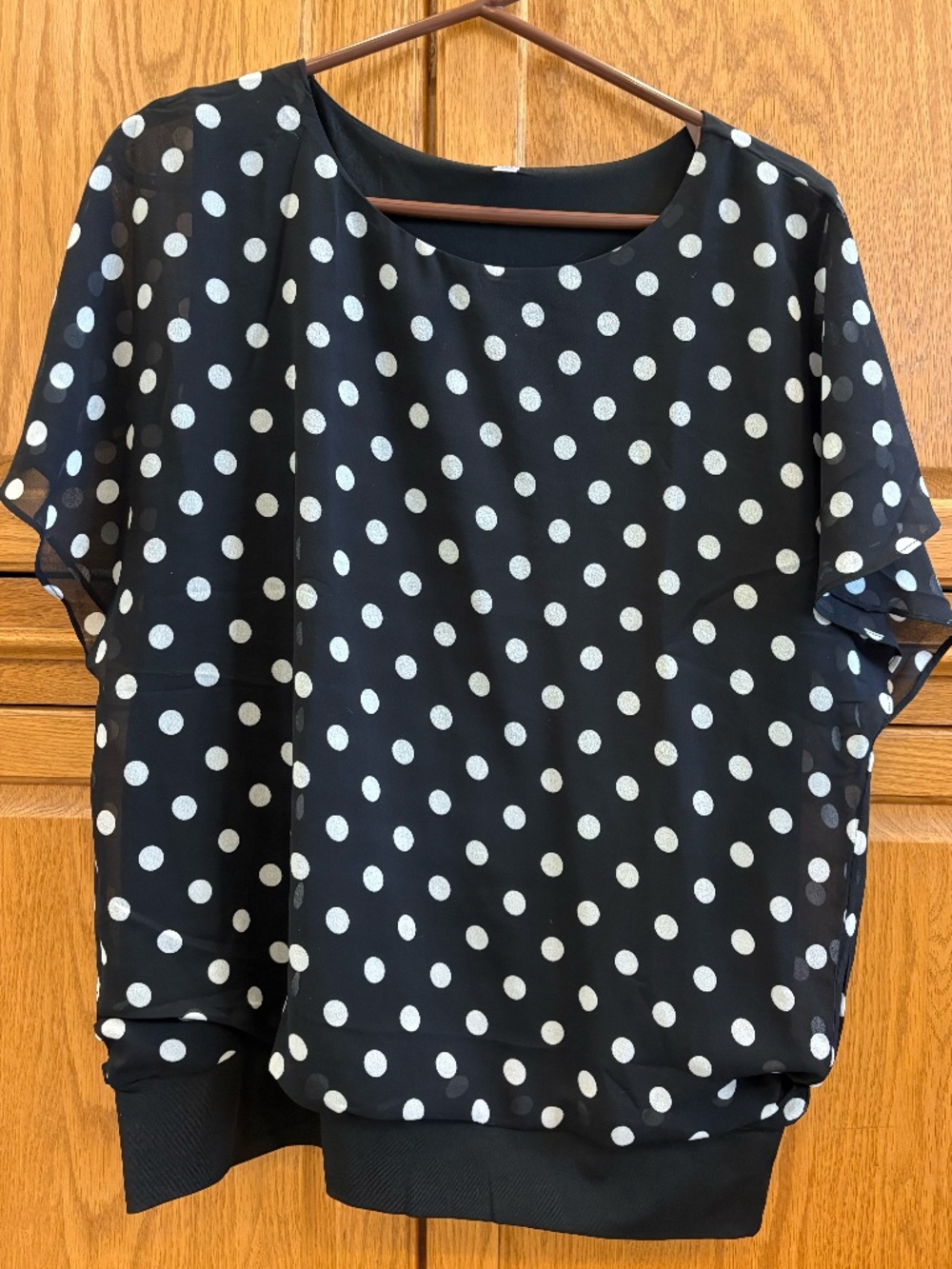 Black polkadot shirt with ruffles on sleeves
